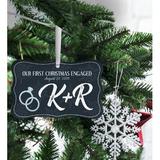 The Holiday Aisle® Our First Christmas Engaged Holiday Shaped Ornament Wood in Blue/Brown, Size 2.5 H x 4.0 W x 0.25 D in | Wayfair