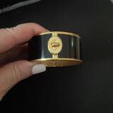 Coach Jewelry | Beautiful Coach Wide Black And Gold Bangle With Turnlock Design. | Color: Black/Gold | Size: Os