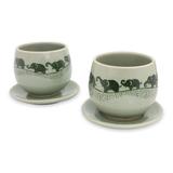 Celadon ceramic teacups and saucers, 'Prancing Elephants' (pair)