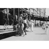 Buyenlarge Woman Lifts Child Off of An Open Sided Trolley Car on New York - Photograph Print in Black/White, Size 28.0 H x 42.0 W x 1.5 D in Wayfair