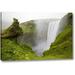 World Menagerie 'Iceland Waterfall Plunges over a Volcanic Cliff' Photographic Print on Wrapped Canvas in Gray/Green | Wayfair