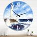 Designart 'Lighthouse On The Rocky Island With Seagulls' Nautical & Coastal wall clock