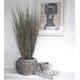 Faux grass plant in a rustic basket planter