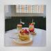 Latitude Run® Cake w/ Two Glasses Of Smoothie On The Table By Window - 1 Piece Square Graphic Art Print On Wrapped Canvas in Pink/Yellow | Wayfair