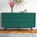 Etta Avenue™ Blanca 7 Drawer Dresser Wood in Brown/Green | 33.5 H x 60 W x 19.25 D in | Wayfair D9E2BFB85E44467EA1DF1679CBE3ECED