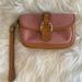 Dooney & Bourke Bags | Dooney & Bourke Pink Monogram Wristlet With Leather Trim And Buckle. | Color: Pink/Tan | Size: 4” H X 6” L