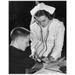 Female nurse checking a young man s blood pressure Poster Print (18 x 24)