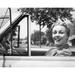 Close-up view of young woman sitting in car and smiling Poster Print (24 x 36)