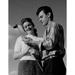 Young couple holding golf club and smiling low angle view Poster Print (18 x 24)