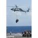 An MH-60S Sea Hawk picks up cargo from USNS Medgar Evers Poster Print by Stocktrek Images (11 x 17)