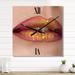 Designart 'Female Lips Close-Up With Red Lipstick, Gold Paint' Modern Large Wall Clock