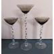 A trio of elegant, vintage, smoked glass candlesticks with twisted stems