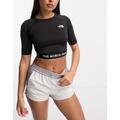 The North Face Training cropped long sleeve performance top in black