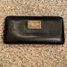 Michael Kors Bags | Michael Kors Black And Gold Wallet (8 1/2 By 4) | Color: Black/Gold | Size: 8 1/2 By 4