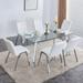 Table and chair set, 1 table and 6 black chairs. Rectangular glass dining table with metal legs armless PU dining chairs