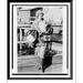 Historic Framed Print [Miss Ruth Law aviator full-length portrait standing facing slightly right carrying two boxes one the map case she designed].Herbert Photos New York. 17-7/8 x 21-7/8