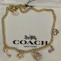 Coach Jewelry | Coach Gold Charm Necklace. | Color: Gold/Pink | Size: Os