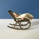 Vintage miniature rocking chair and baby.