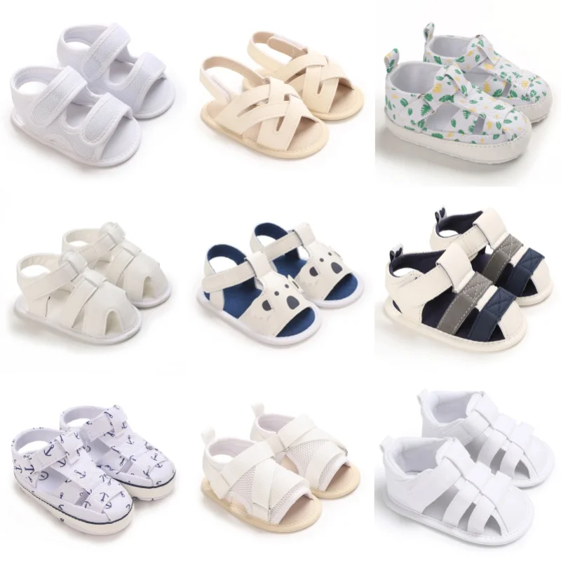 Neue weiße Sommer-Cartoon-Druck 0-18 Monate Herren-Baby-Sandalen mit Stoffsohle, rutschfeste Baby-Sandalen und Wanderschuhe