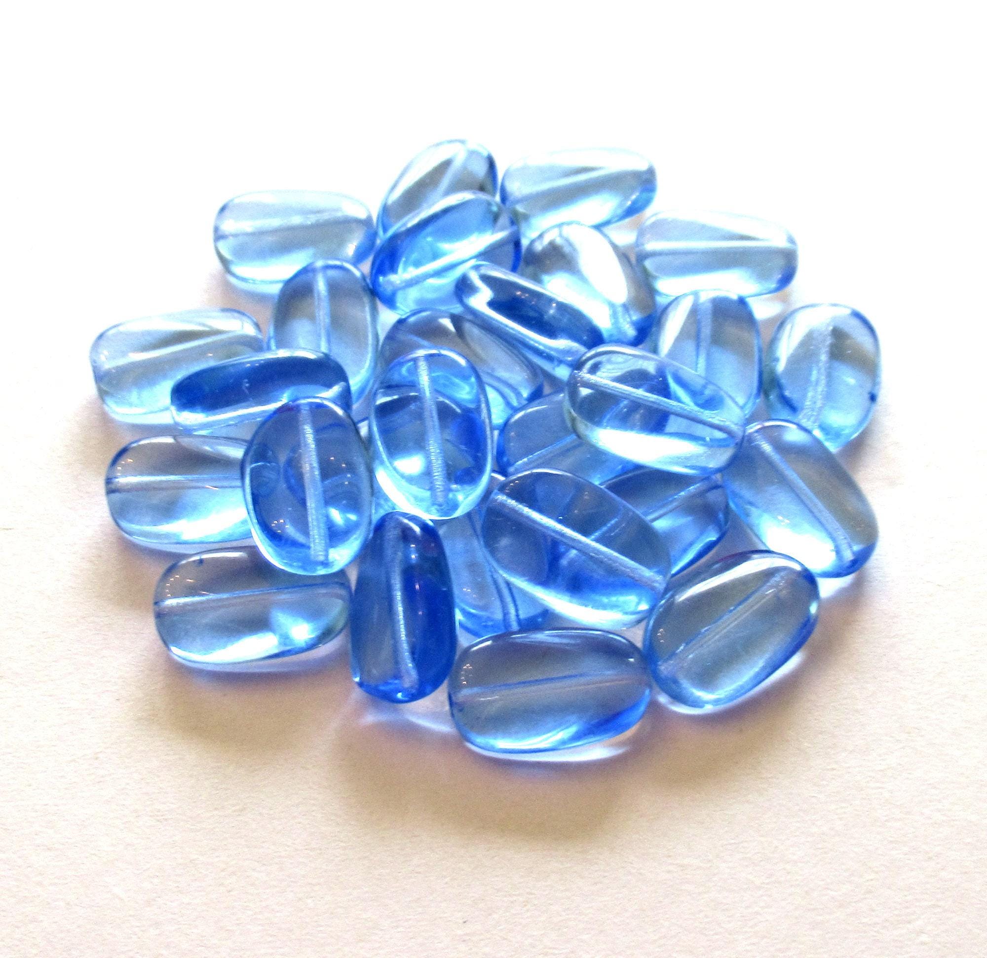 Lotto di 15 perle di vetro ceco ovali leggermente ritorte color zaffiro chiaro trasparente - perle di vetro pressato da 14 mm x 8 mm C0032