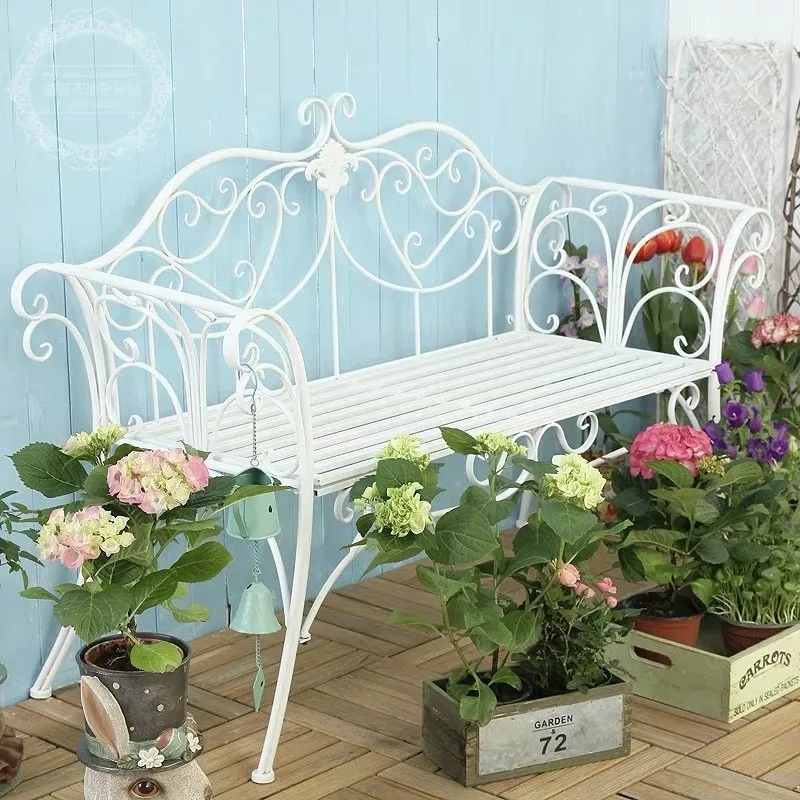 Outdoor garden benches, outdoor wrought iron table and chairs, three-piece set of open-air balcony, courtyard, park, photography